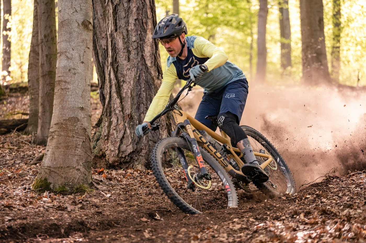 Mountain biker flowing through a forest trail.